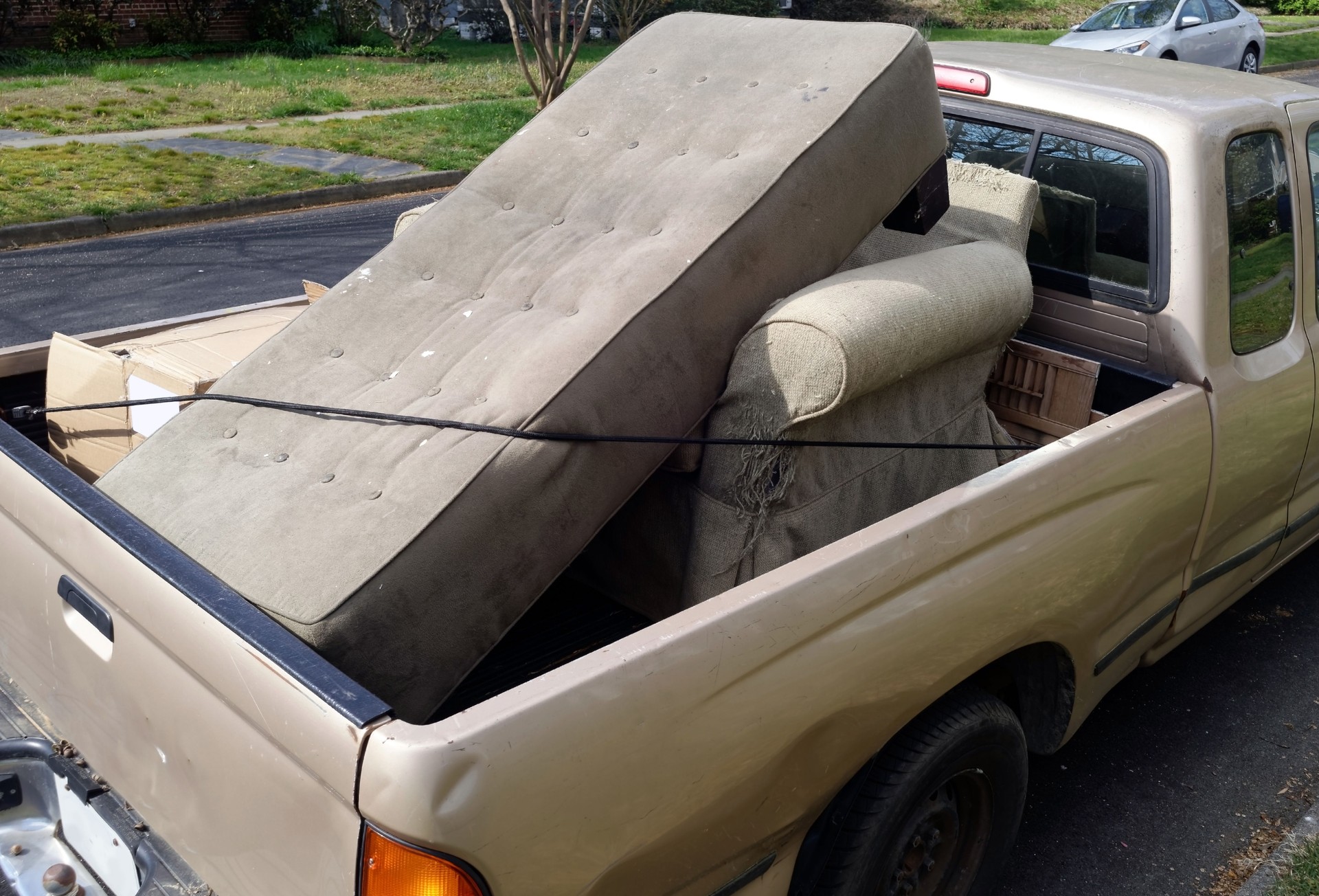 Filthy Sofa and Debris in Back of Pickup